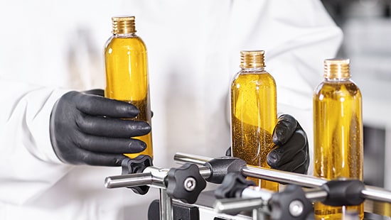 Three bottles of liquid in a personal care and cosmetics facility